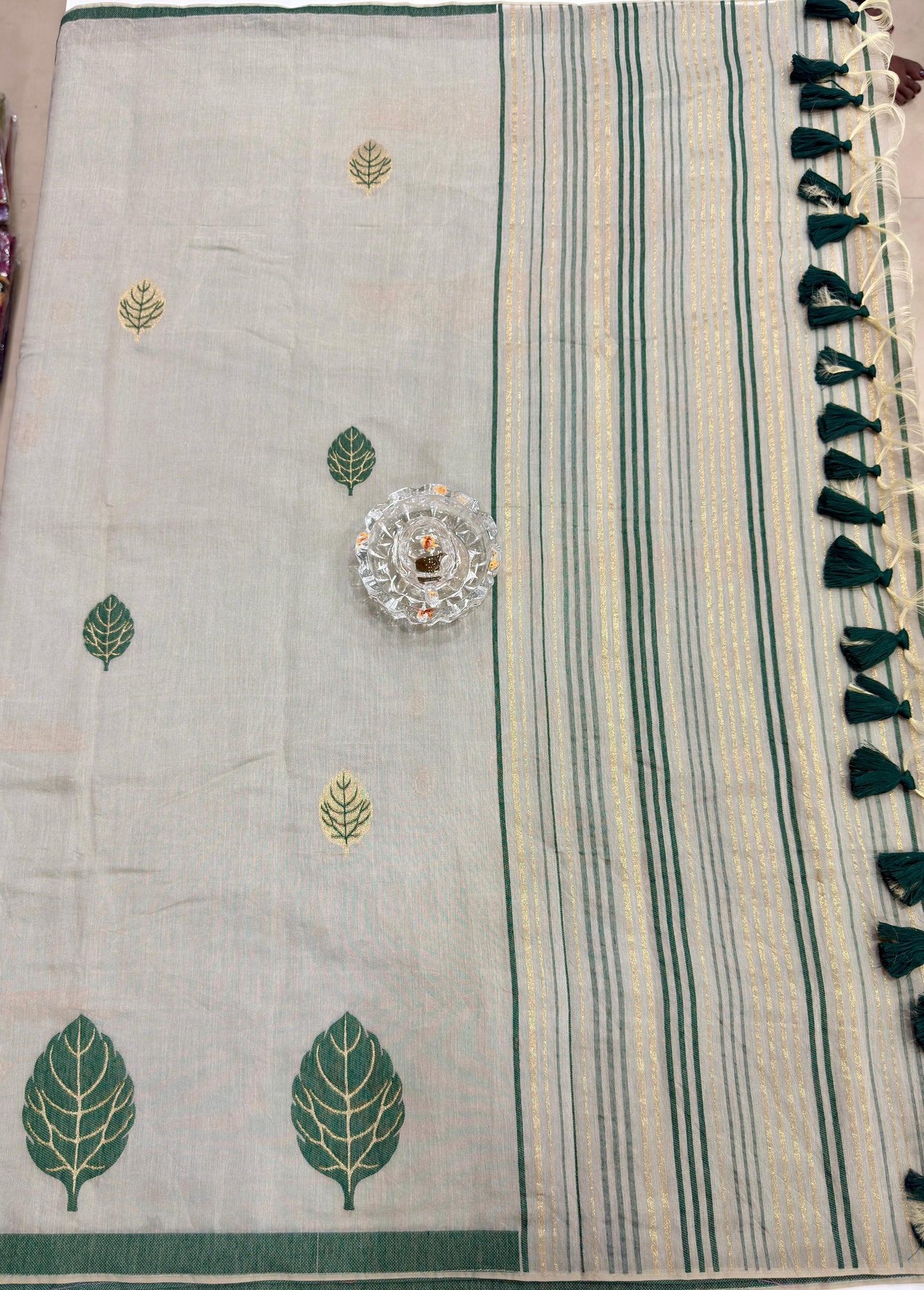 Green kora silk style viscose saree with woven detailing, tassel pallu and embroidered unstitched blouse fabric for women