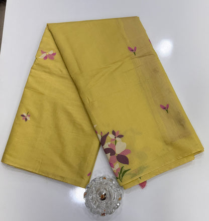 Yellow kora silk style viscose saree with woven floral motifs, tassel pallu and embroidered unstitched blouse fabric for women